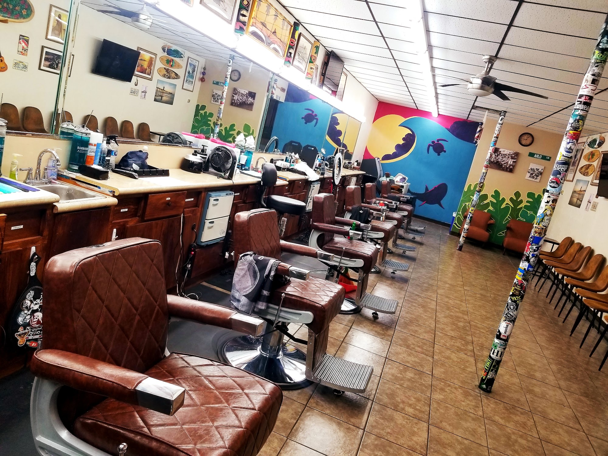 Inside PH Barber — barber chairs and colorful mural